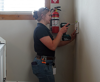 GVTC technician installing smart home security equipment